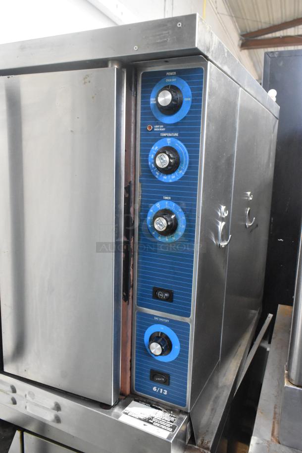 Duke 6/13 stainless steel gas convection oven with view-through door, solid door, metal racks, and thermostatic controls.