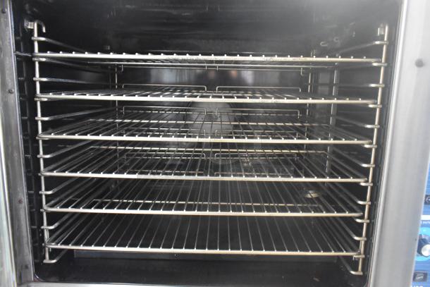 Duke stainless steel commercial convection oven, gas powered, solid and view-through door, metal racks, thermostatic controls.