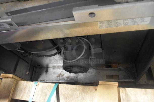 Duke stainless steel commercial convection oven, interior view showing motor and wiring, metal frame, and vent details.