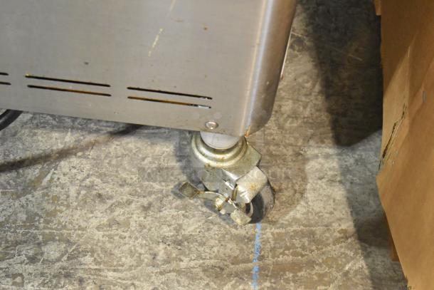 Wellspring SSI-143S stainless steel soft serve ice cream machine caster, shows wear, 220V, 1 phase.