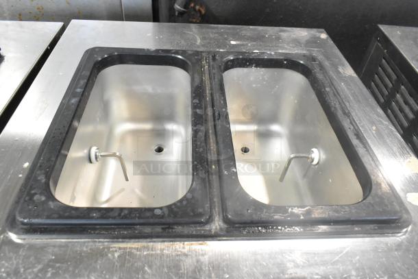 Wellspring SSI-143S stainless steel soft serve ice cream machine with dual bins, commercial casters; 220V, 1 Phase.