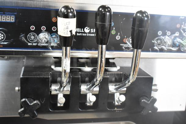 Wellspring SSI-143S stainless steel soft serve ice cream machine with 2 flavors plus twist option. 220V, 1 phase. Commercial casters.