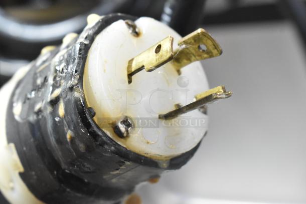 Close-up of a plug for the Wellspring SSI-143S Soft Serve Ice Cream Machine. Plug shows minor wear.