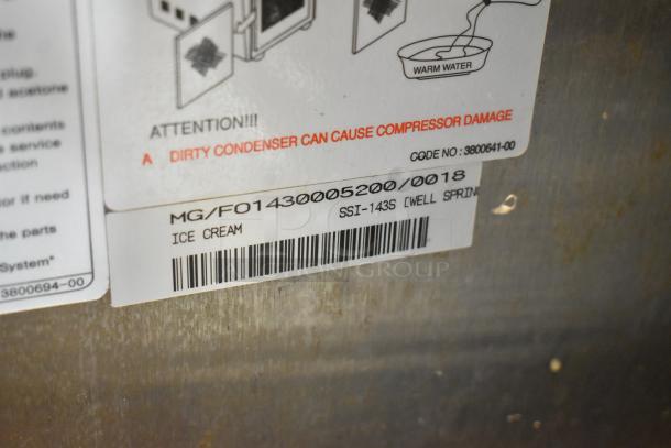 Wellspring SSI-143S stainless steel soft serve ice cream machine label, highlighting model and voltage details.