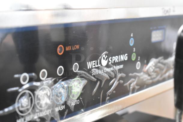 Wellspring SSI-143S stainless steel soft serve ice cream machine, 2-flavor with twist, commercial casters, 220V, 1 phase.