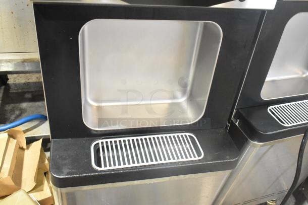 Wellspring SSI-143S stainless steel 2-flavor twist soft serve ice cream machine, floor style, on casters, 220V, 1 phase.