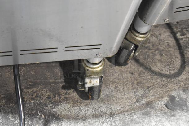 Wellspring SSI-143S ice cream machine caster wheels on a commercial floor. Visible signs of wear.