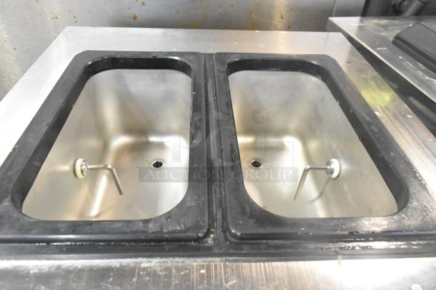 Wellspring SSI-143S stainless steel soft serve machine, dual tanks, seen on commercial casters. 220V, 1 phase. Clean condition.