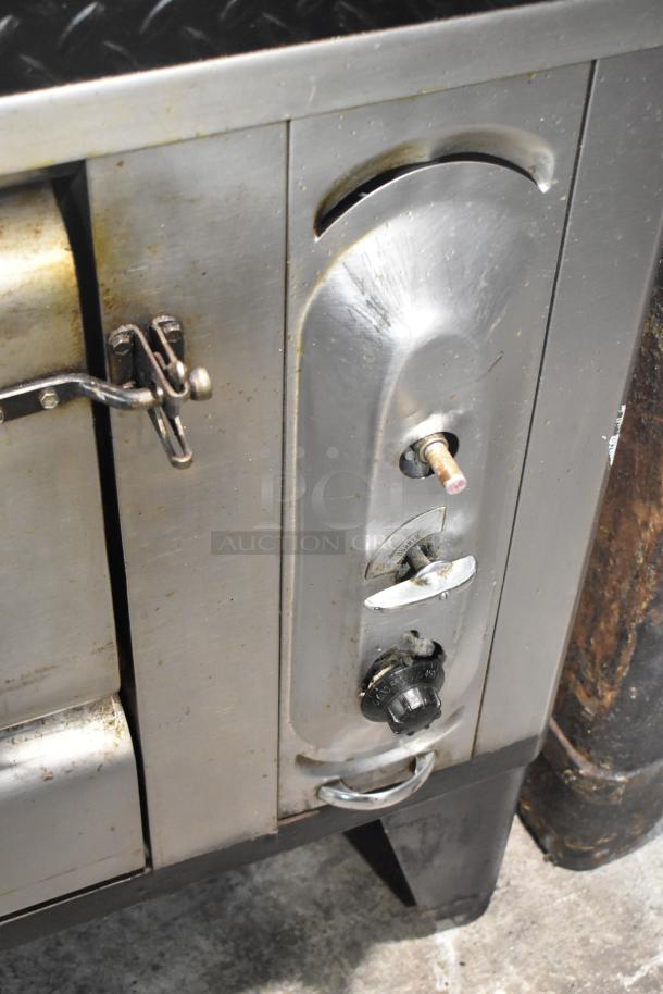 Blodgett stainless steel commercial gas pizza oven panel, showing knob controls and metal latches, in used condition.