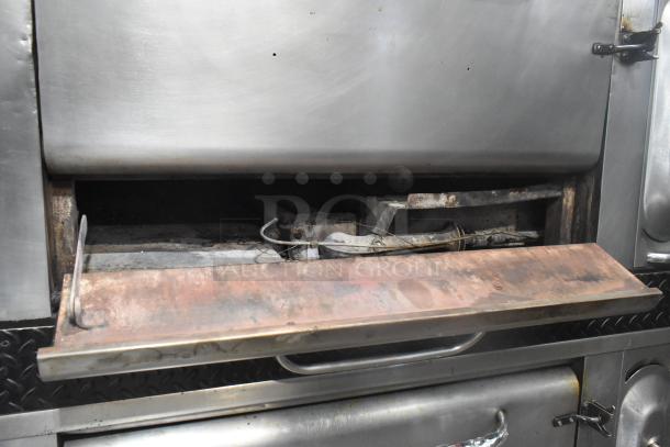 Blodgett stainless steel commercial gas pizza ovens with cooking stones, visible wear on the deck, handles, and interior components.