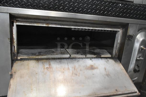 Blodgett stainless steel commercial gas pizza oven, single deck with cooking stones. Used condition with visible wear.