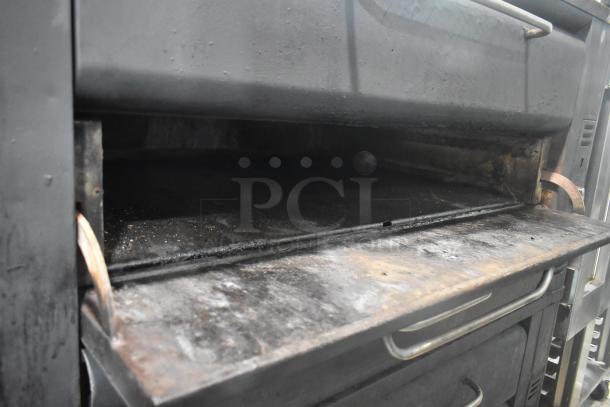 Blodgett 981 stainless steel commercial double-deck pizza oven, natural gas, 50,000 BTU, visible wear, natural gas powered.