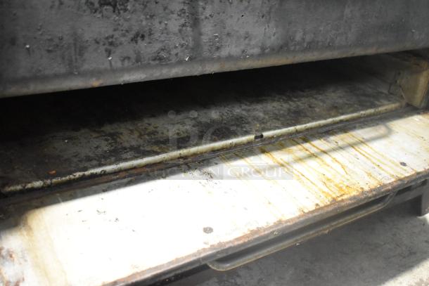 Blodgett 981 stainless steel commercial pizza oven, natural gas, 50,000 BTU, 2-deck, visible wear on interior floor.