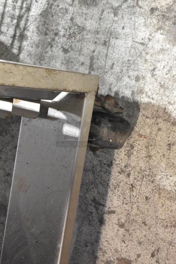 Baxter stainless steel rotating rack oven on a double pan rack with commercial casters, some wear visible.