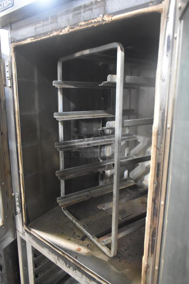 Baxter stainless steel mini rotating rack oven, natural gas powered, with double pan rack and commercial casters, used condition.