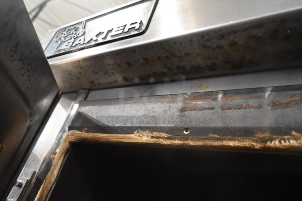 Baxter stainless steel commercial oven, natural gas, visible wear. Features rotating rack, double pan rack, commercial casters.