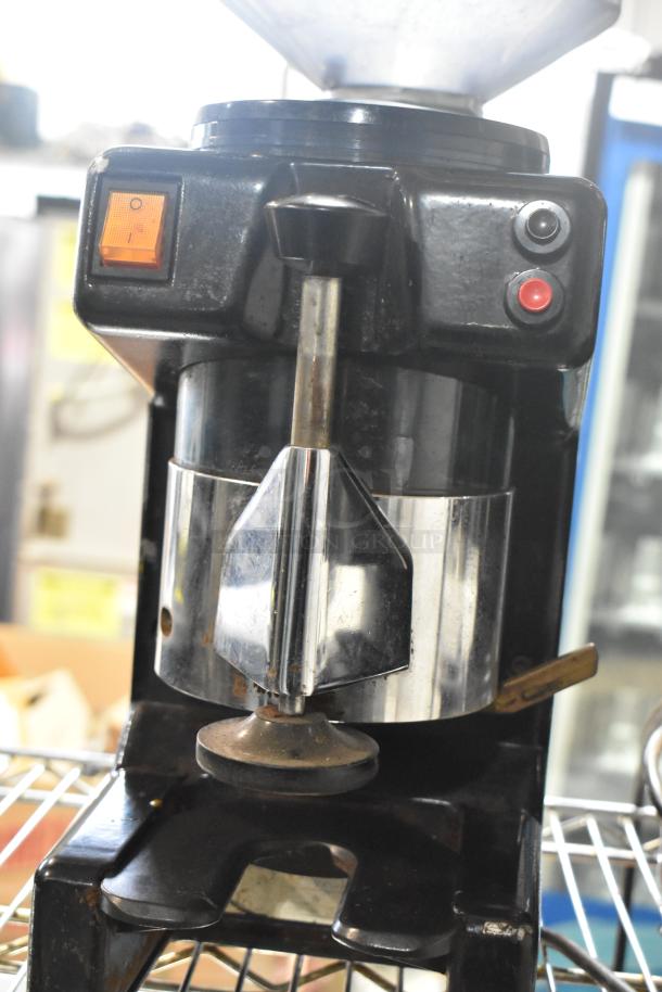 Bregani 42330 metal commercial espresso bean grinder, countertop model in used condition, 120 volts, 1 phase. Features control buttons.