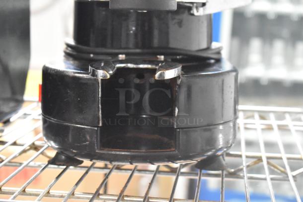 Gino Rossi RR45 metal commercial espresso bean grinder, black, countertop model, 120 volts, visible wear on base.