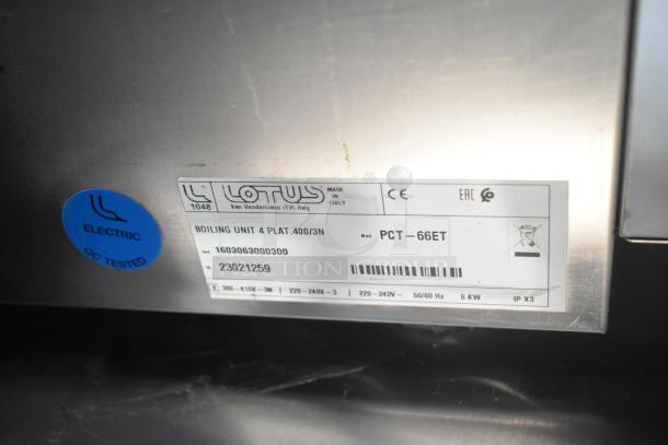 2023 Lotus PCT-66ET stainless steel 4-burner electric range. Countertop design, model and serial number visible. QC tested.