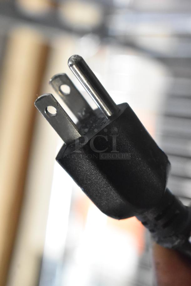 Close-up of a power plug for the 2023 Cooltech CUST-48LB Stainless Steel Commercial Single Door Chef Base, 115 Volts, 1 Phase.