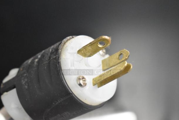 Close-up of a power plug with metal prongs for the Aspes Stainless Steel Commercial Undercounter 2 Door Cooler.