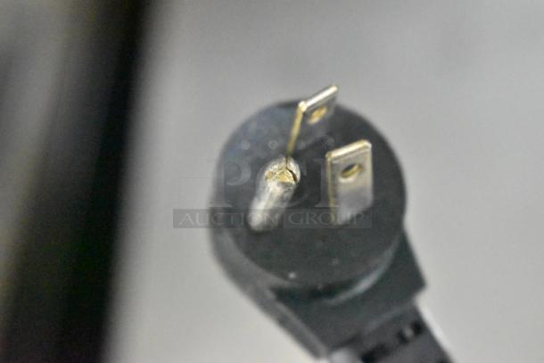 Close-up image of the power plug for the Delfield 406CA-DD1 undercounter cooler, showing a standard 115-volt plug.