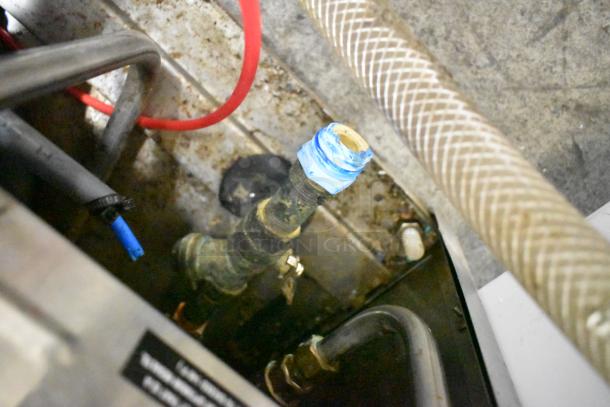 CMA L-1X16 stainless steel commercial undercounter dishwasher interior details. Includes plumbing and connector elements.