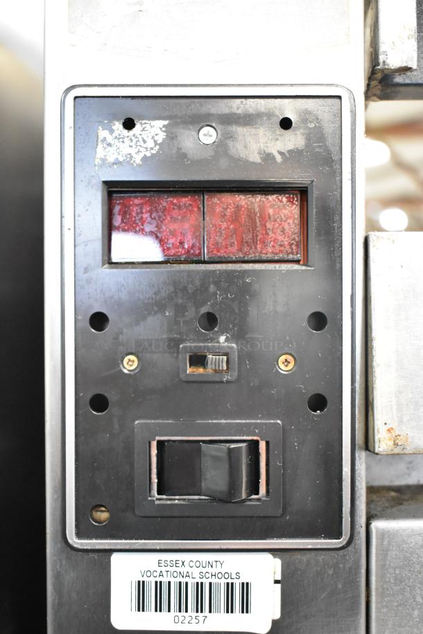 Close-up of Traulsen AHT 2-32 WUT cooler panel with red indicators and a switch. Essex County Vocational Schools label visible.