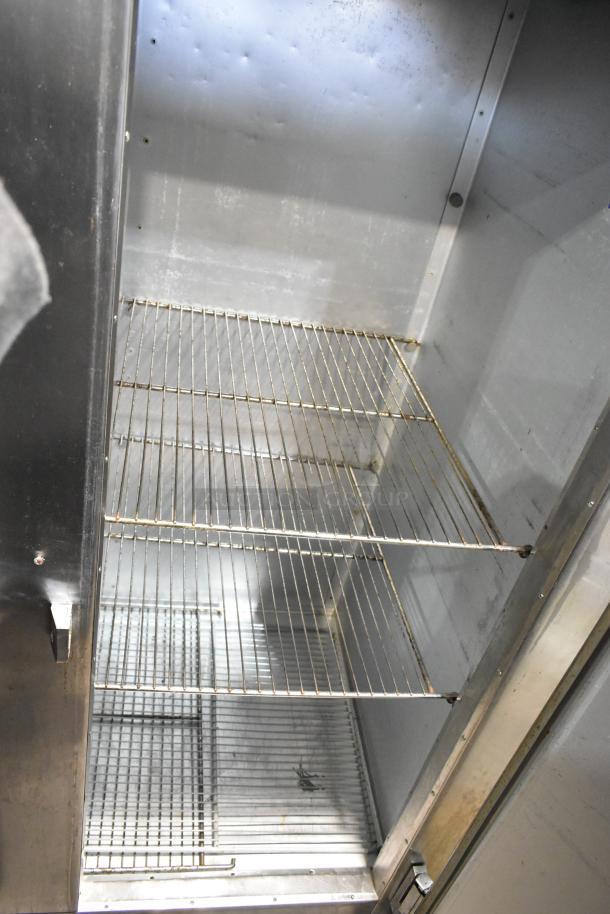 Traulsen AHT 2-32 WUT stainless steel 2-door reach-in cooler with racks, 115V, 1 Phase, commercial-grade, interior view.