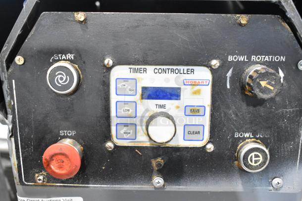 Hobart HF 270 dough mixer control panel with buttons for start, stop, bowl rotation, and timer. Visible wear on controls.