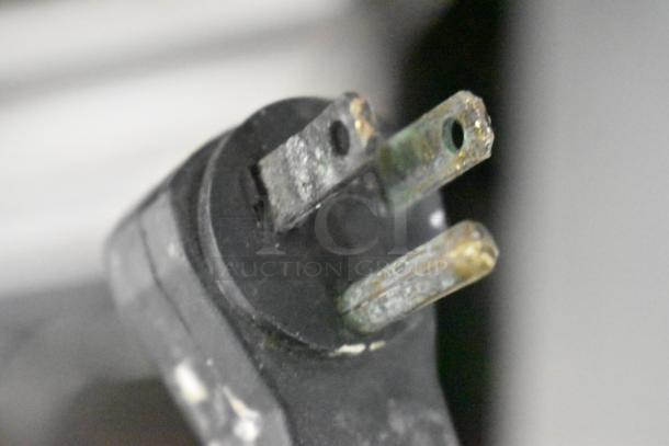 Close-up of a worn power plug from a Beverage Air MT45 commercial cooler, indicating potential use and wear.