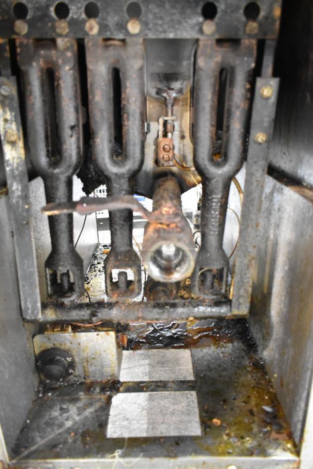 Tri-Star stainless steel commercial gas fryer, includes 2 metal fry baskets. Visible internal components, signs of wear.