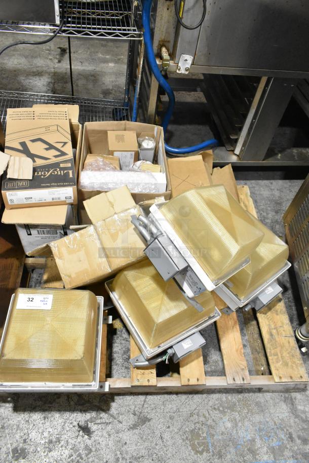 Pallet lot of various light fixtures, including emergency lights, in boxes. Visible brands include LiteSource. Mixed condition.