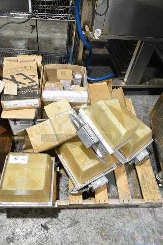 Pallet lot of various light fixtures, including emergency lights, in boxes. Visible brands include LiteSource. Mixed condition.
