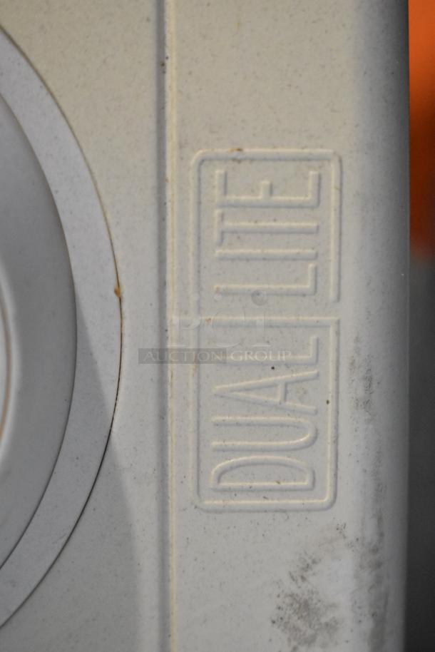 "Dual-Lite" embossed on a light fixture component, slightly worn condition. Part of a pallet lot including emergency lights.