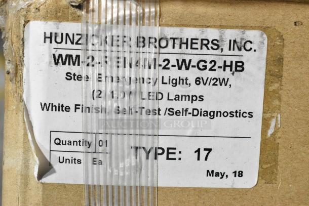 Label on a cardboard box for Hunzicker Brothers WM-2-RE1M-2-W-G2-HB emergency light, 6V/2W, white finish, self-test.