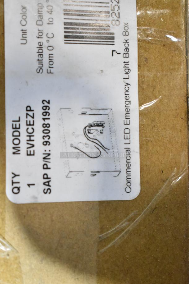 ALL ONE MONEY! Pallet lot with various light fixtures, including model EVHCEZP emergency light. Suitable for damp locations.