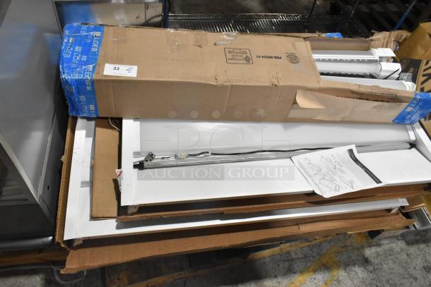 Pallet lot including Day Brite light fixture and Lumination LUR2 Series light, partially boxed, various conditions.