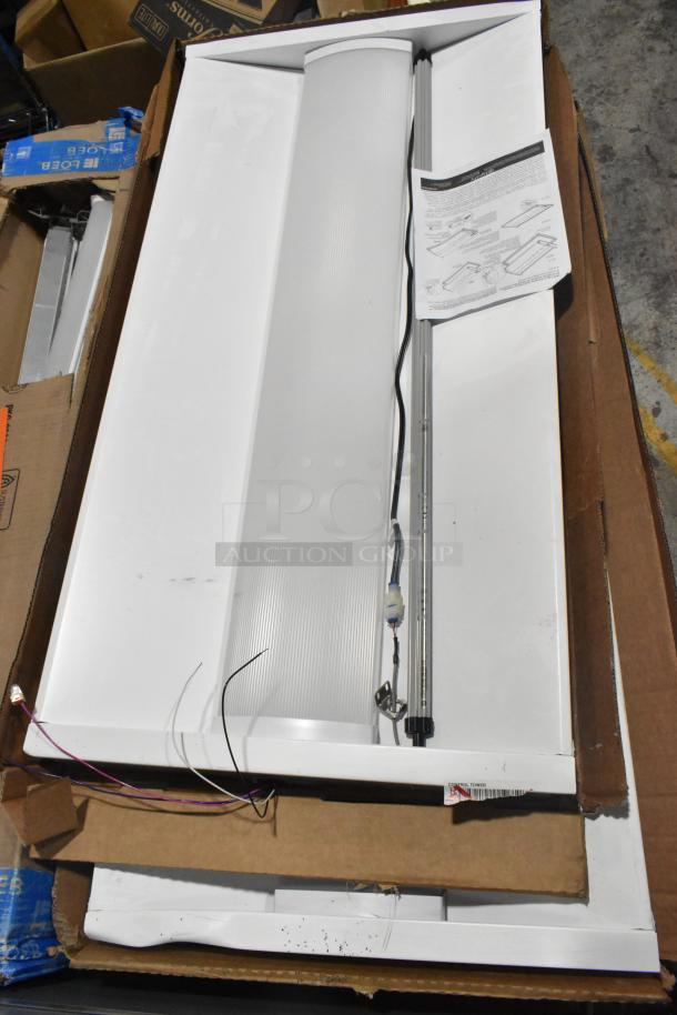 Pallet lot with Day Brite light fixture and Lumination LUR2 Series light, visible wires and installation guide included.