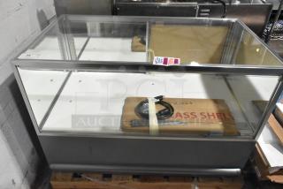 WM19SGMOD Display Case Merchandiser, 120 Volts, 1 Phase. Glass front, metal frame, includes power cord. Good condition, fragile label visible.