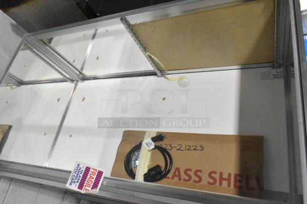 WM19SGMOD Display Case Merchandiser, 120 Volts, 1 Phase. Features glass shelves, marked "Fragile," new in box.