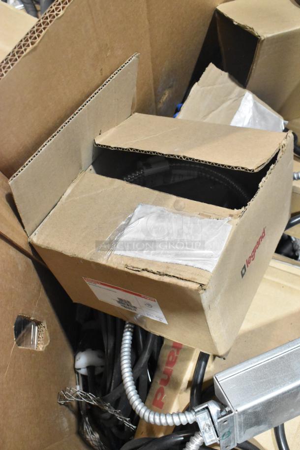 Pallet lot with Critical Cover AquaTank shoe covers, wires, Wiremold CDBB1420C-40BK CD with outlet box in cardboard boxes.