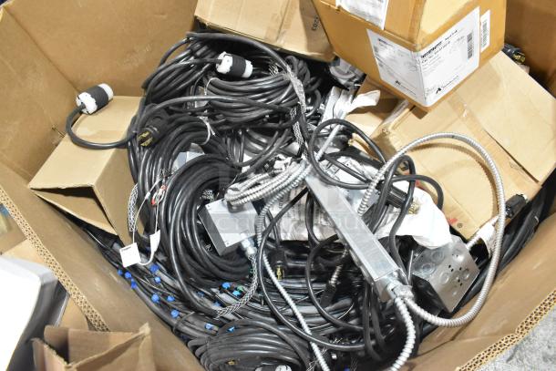 Pallet of mixed items, including Critical Cover AquaTank shoe covers, wires, Wiremold CDBB1420C-40BK CD with outlet box.