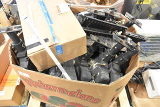 Pallet lot of various items including outdoor light fixtures, packaged in a large cardboard box on a wooden pallet, mixed condition.