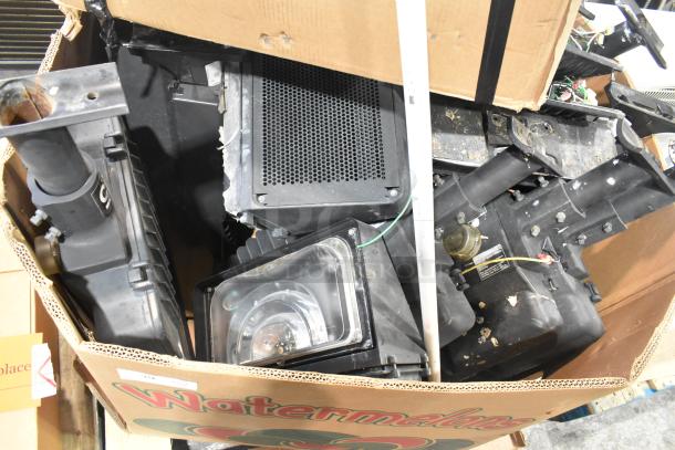 Pallet of assorted items including various outdoor light fixtures, visible wear, housed in a cardboard box labeled "Watermelon."