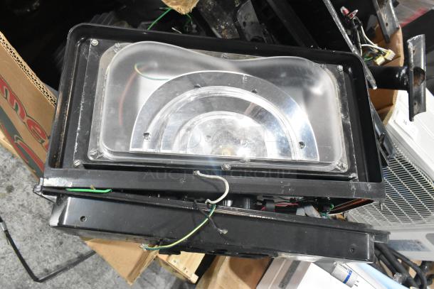 Pallet of various items including a black outdoor light fixture with visible wiring, in used condition.
