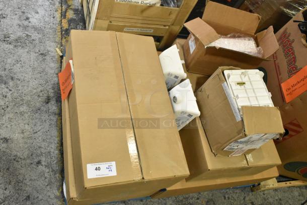 Assorted items with General Electric light fixtures from the Current Evolve LED series, packed in boxes. Visible labels indicate auction item lot.