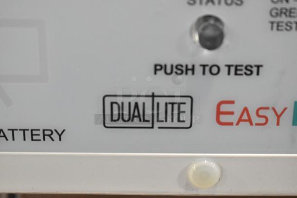 Close-up of a Dual Lite panel with "Push to Test" button and Easy logo. Part of 8 various items auctioned, including GE light fixtures.