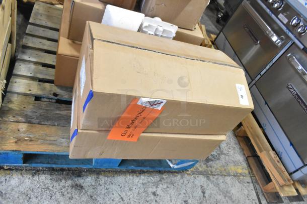 Cardboard boxes containing General Electric light fixtures on a pallet. Boxes have labels and shipping barcodes.