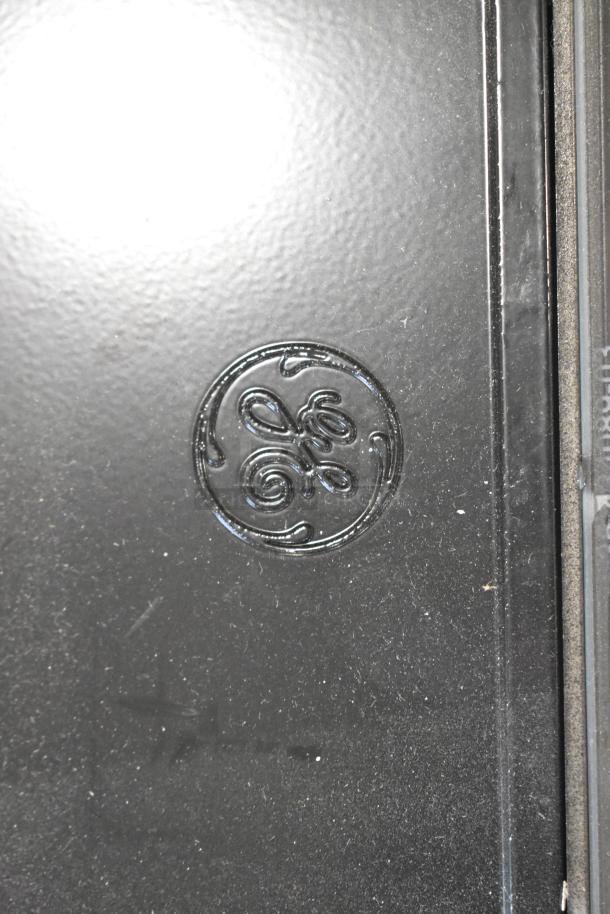 Black General Electric light fixture with logo embossed on the surface, part of Current Evolve LED series.